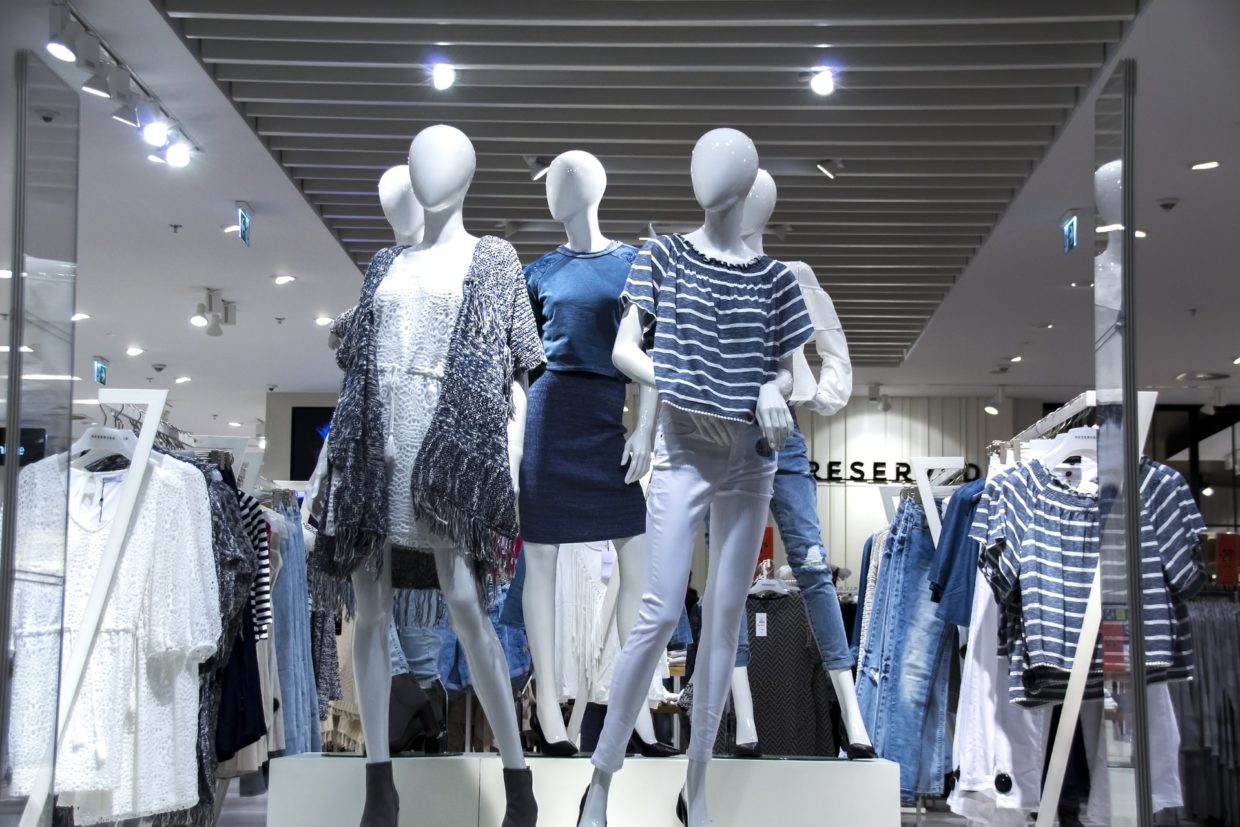 Mannequins posed in a department store window.